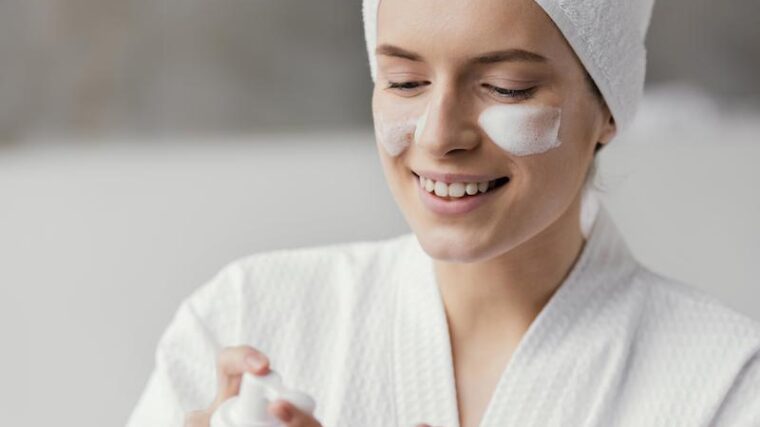 Kvinna med ansiktskräm på kinden